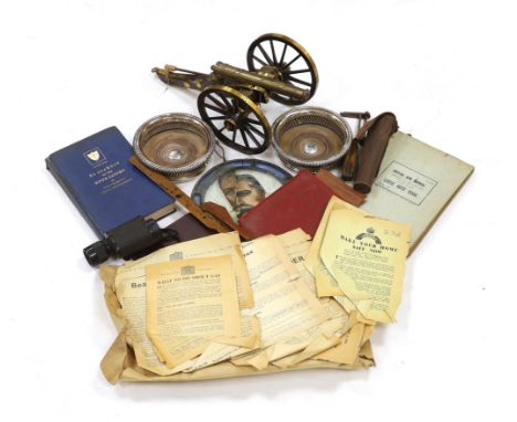 A collection of militaria, including a brass model of a Napoleonic era field gun, a stained glass panel, a Royal Air Force no