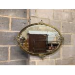 An Edwardian oval brass wall mirror width 87cm, height 64cm.