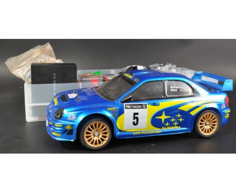 An original Diagostini / Bycmo made 1/10 scale part built RC Radio Control model kit of a Subaru Impreza rally car along with