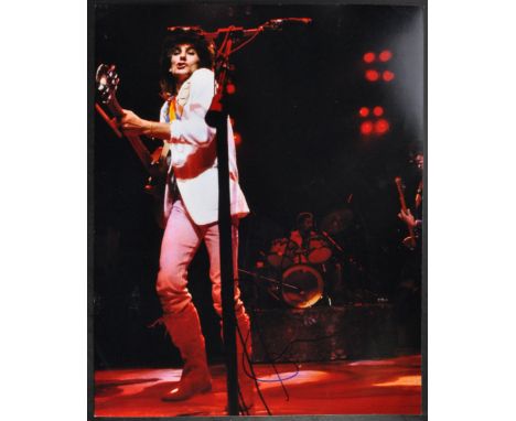 Ronnie Wood - The Rolling Stones (Guitarist) - autographed 11x14" colour photograph of Wood on stage. Signed in blue ink to a