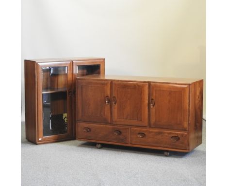 An Ercol elm windsor sideboard, 130cm, together with a similar glazed bookcase