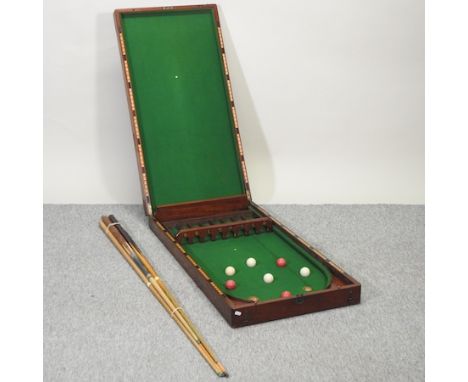 A Victorian mahogany cased folding bagatelle, 212cm long overall, together with balls and cues