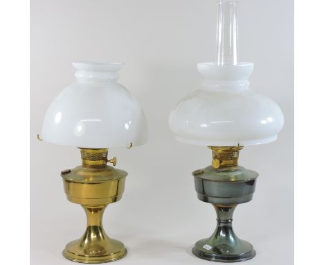 A brass oil lamp, with a white glass shade, 62cm high, together with another similar