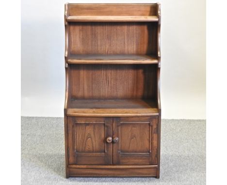 An Ercol elm waterfall bookcase, 61cm