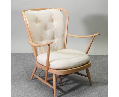 An Ercol light elm armchair, with loose cushions