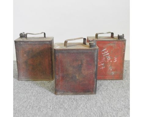 A collection of three vintage petrol cans, tallest 32cm high