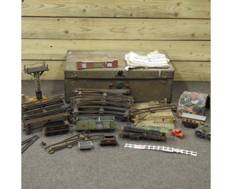 An antique tin trunk, containing Hornby O gauge train and track