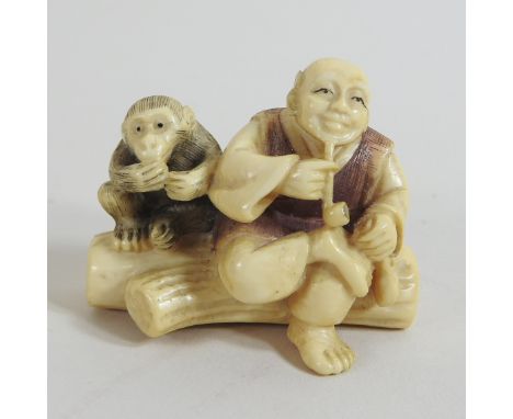 A Japanese carved ivory netsuke, in the form of a man and a monkey, seated on a log, signed, 4cm high