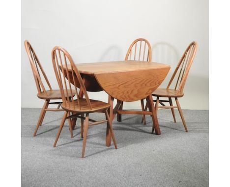 An Ercol light elm drop leaf dining table, 113 x 126cm, together with four Ercol hoop back dining chairs