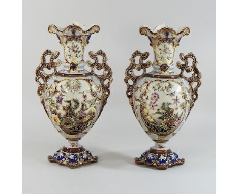 A pair of Zsolnay style floral decorated two handles vases, 37cm high