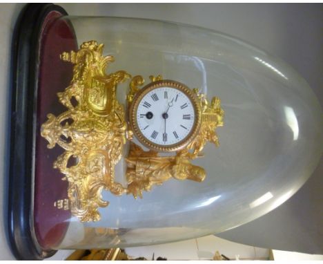 A late 19th/early 20thC French ornately cast, gilded spelter and grey alabaster cased mantel timepiece, featuring a standing 