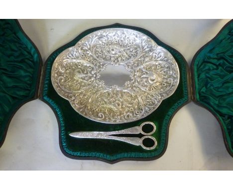 A late Victorian silver presentation fruit dish of oval, quatrefoil outline, cast and chased around a vacant, central cartouc