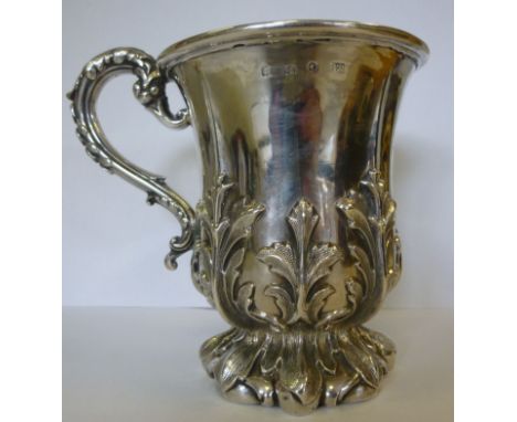 An early Victorian silver Christening tankard of tulip design, cast and chased with foliate designs, having an S-shaped handl