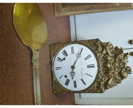 A late 19thC hanging Comptoise clock with a decoratively pressed brass face and pendulum; the bell strike movement faced by a