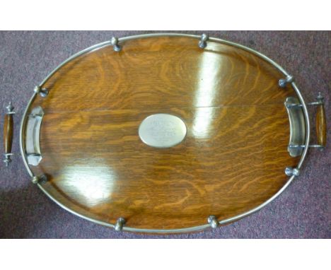 An Edwardian light oak, galleried oval serving tray with electroplated mounts and opposing bar handles, on bun feet  15'' x 2