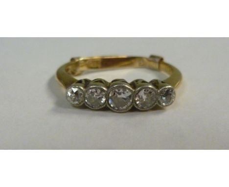 A gold coloured metal, five stone, claw set diamond ring