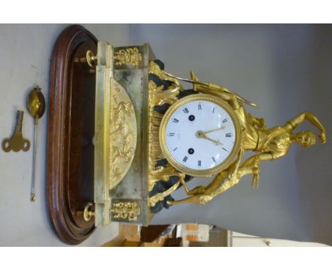 A late 19thC French ornately cast and black painted, drum shaped, gilt metal ormolu cased mantel clock, featuring Diana the H