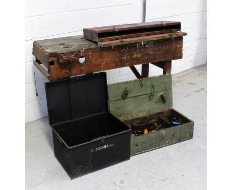 A vintage tool bench with an attached Parkinson clamp and a vintage toolbox containing a quantity of vintage tools to include