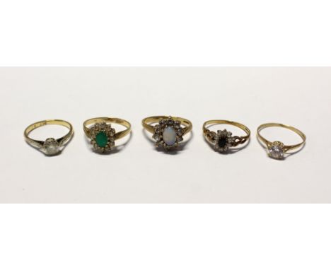 Five 9ct gold ladies' dress rings; a floral-set example with central green stone and white stone surround, size P, two with s