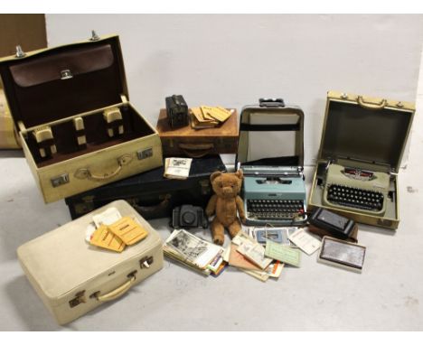 A large black vintage suitcase and a vintage cream suitcase, a small brown leather document case, a mid-20th century Antler c