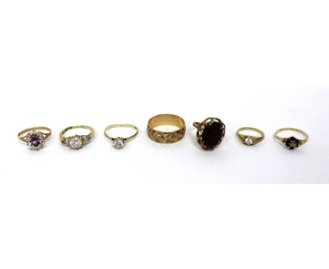 A 9ct gold ladies' wedding band, size R and six ladies' dress rings, various settings to include floral, solitaire and a trip