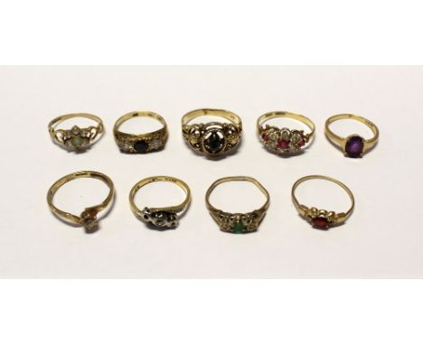 Nine 9ct gold ladies' dress rings to include a floral-set example with red and white stones, size O 1/2, a solitaire white st