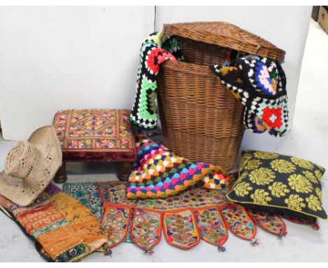 An Alibaba-style linen wicker basket containing a quantity of textiles to include three vintage crochet multicoloured blanket