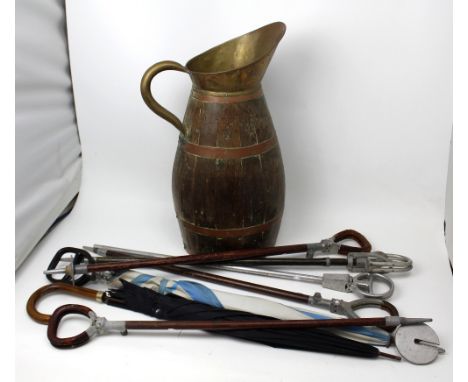A large wooden jug with copper bands containing six vintage shooting sticks and a gentlemen's umbrella (8).