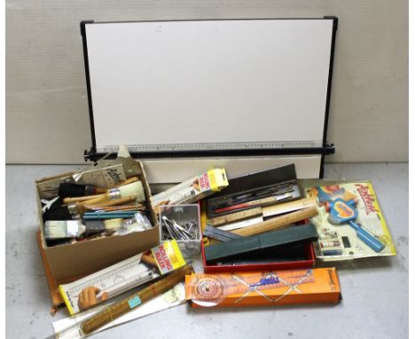 A selection of artist's equipment to include precision drawing instruments, vintage rulers, air brushing equipment, paint bru