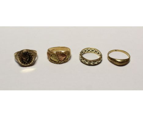 A thaler set in a 9ct gold mount, size M, a 9ct yellow and rose gold dress ring with leaf design, size K, a 9ct gold ladies' 