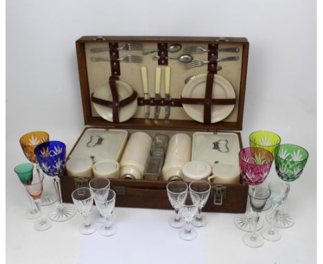 A vintage picnic set with cutlery, plates, saucers, flasks and sandwich containers and a quantity of cut glass wine glasses t