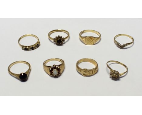 Eight 9ct gold ladies' dress rings to include a buckle ring, size L, a signet ring, size P, a floral-set ring with central op