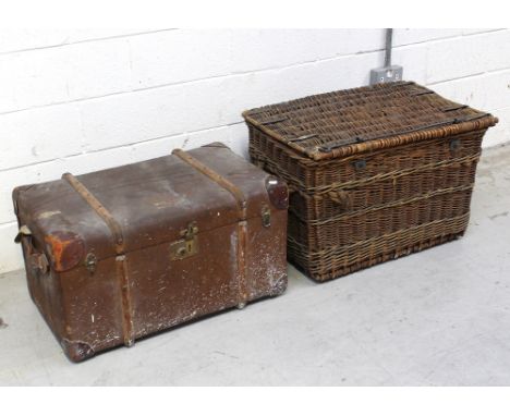 A large vintage wicker travel basket with rope handles to either side, length 77cm and a vintage travel trunk with wood and m