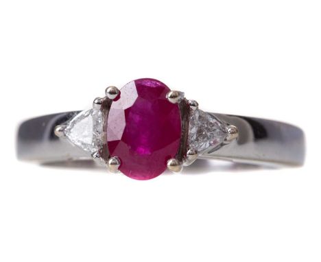 RUBY AND DIAMOND RING,the oval ruby of approximately 1.00 carat, flanked by trillion cut diamonds totalling approximately 0.1