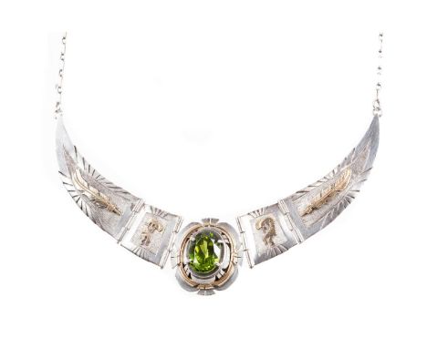 SILVER GEM SET NAVAJO NECKLET BY RUSSELL SAM,with central oval green gem flanked by tribal motifs, signed to the reverseWorn 