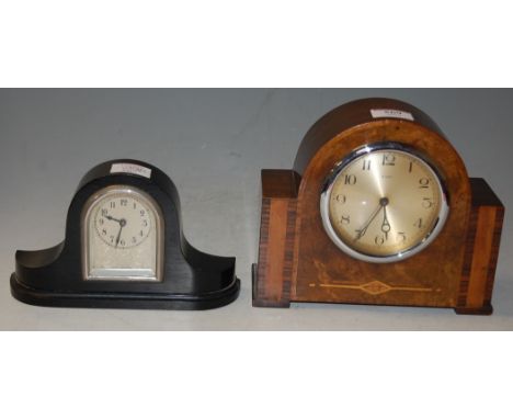 An Art Deco walnut cased mantel clock, having silvered dial with Arabic numerals; together with an ebony cased mantel clock (