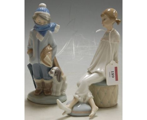 A Lladro figure modelled as a girl seated on a pouffe height 19cm together with one other Lladro figure of a boy and dog Cond