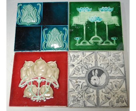 A collection of various early 20th century ceramic tiles