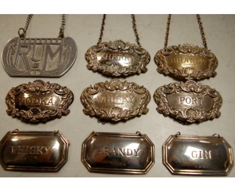 A matched set of five silver decanter labels in the Georgian style, to include brandy, whisky, port, vodka and sherry, maker 