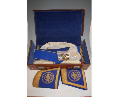 A mid-20th century leather case containing masonic regalia to include; armband, sashes, enamel badges etc 