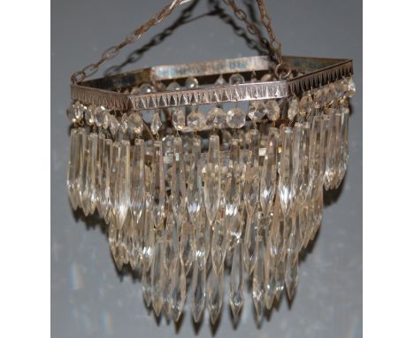 An early 20th century three-tier ceiling light fitting with glass prism drops