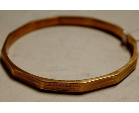A 9ct gold and engine turned bangle 17.2g