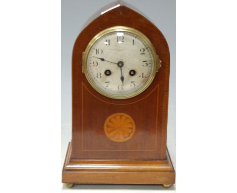 An Edwardian mahogany and satinwood inlaid lancet shaped mantel clock, having silvered dial with Arabic numerals, by the Alex