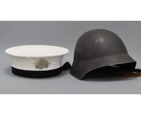 A WWII helmet and a sailor's cap