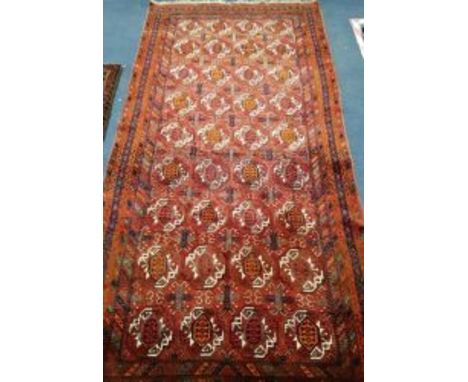 A Bokhara red ground carpet 260 x125cm