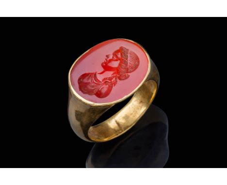 Ca. AD 180 - 235.A carnelian intaglio with a left profile portrait of an empress, possibly Julia Mamaea. The hair is styled i