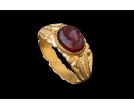 Ca. AD 200 - 300.A carnelian intaglio depicting the portrait of an empress. The intaglio is oval in shape with a smooth, poli