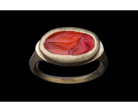 Ca. AD 50 - 300.An oval-shaped carnelian intaglio engraved with a simplified image of Minerva standing in profile. The figure