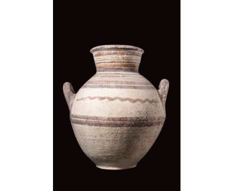 Ca. 750 - 600 BC.A painted terracotta amphora standing on a disc foot. The rounded body is decorated with a broad band of umb