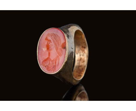 Ca. AD 1 - 200.A carnelian intaglio with the engraved profile of a noblewoman facing left. The portrait displays a finely car